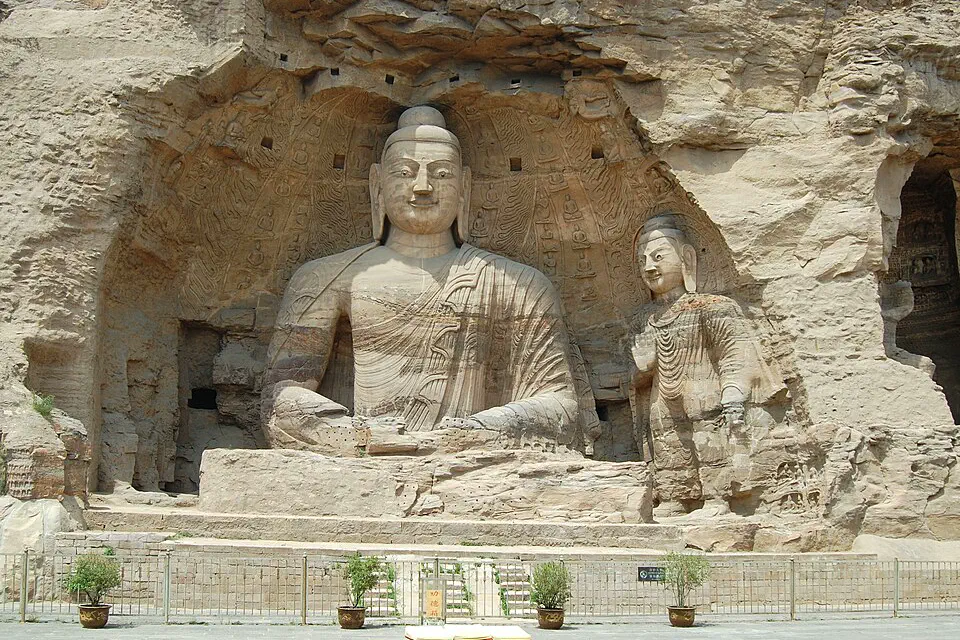 Large seated Buddha carved into the sandstone cliffs at Yungang Grottoes near Datong