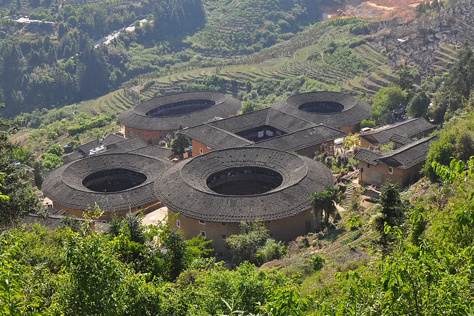 Round and square Fujian tulou clustered among terraced hills