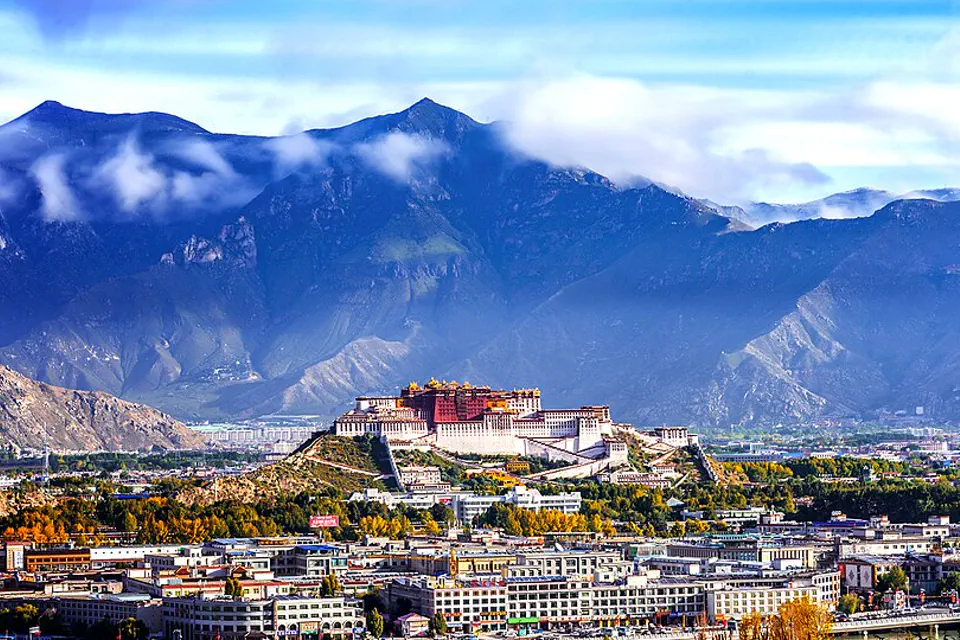 Potala Palace rising above Lhasa against high mountain ridges