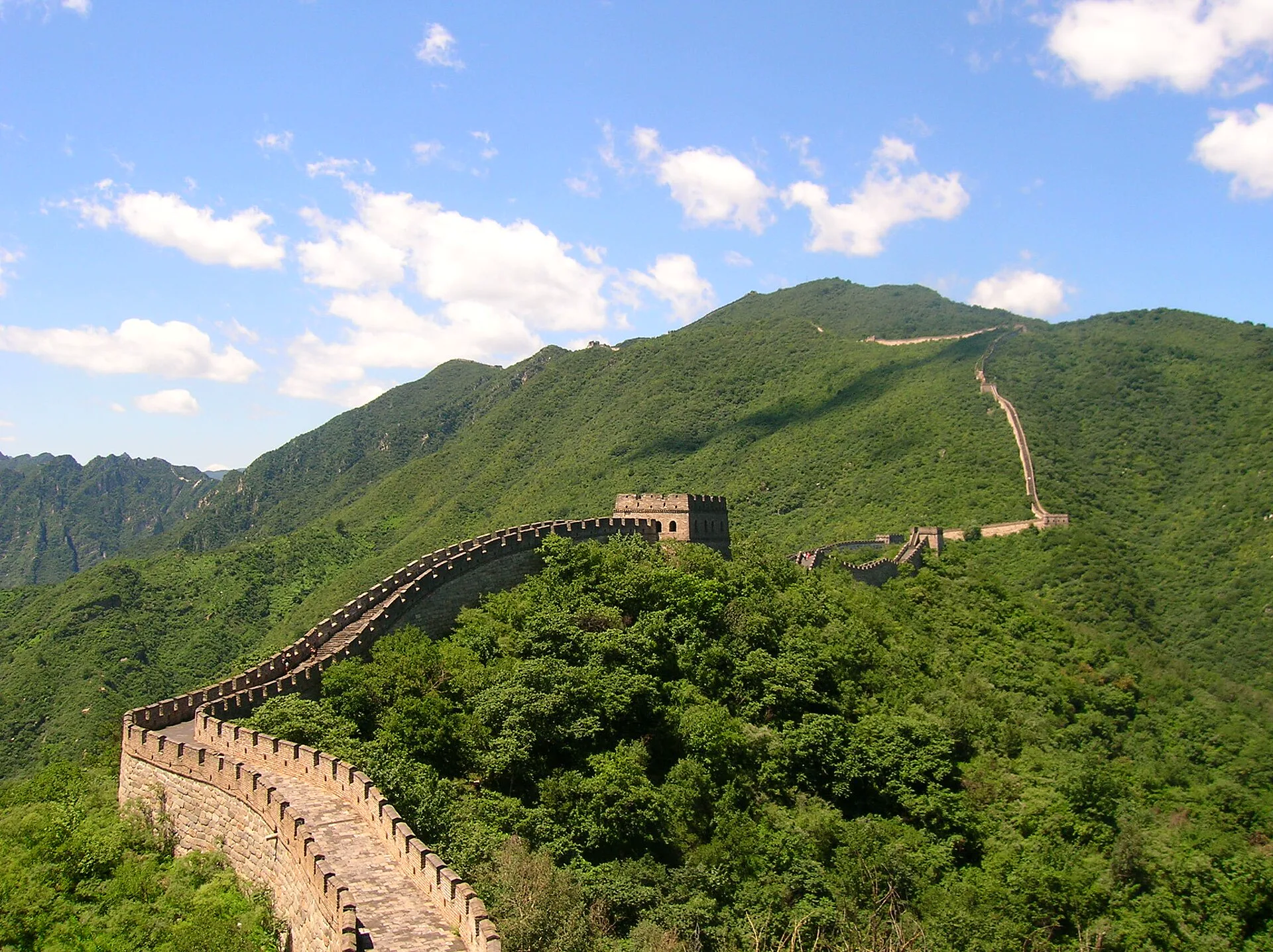 Great Wall watchtowers following a green mountain ridge near Beijing