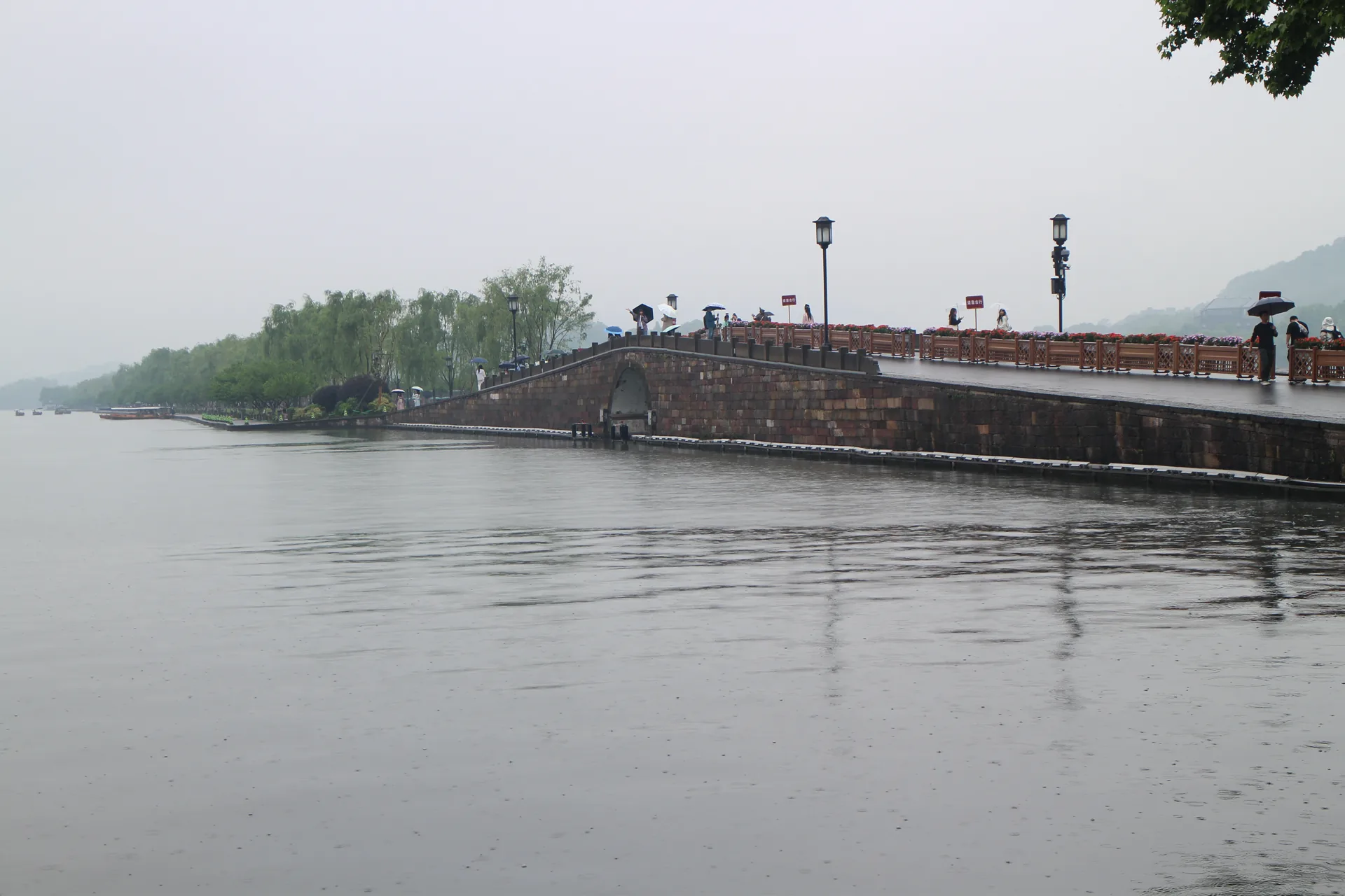 Broken Bridge crossing the misty water of West Lake
