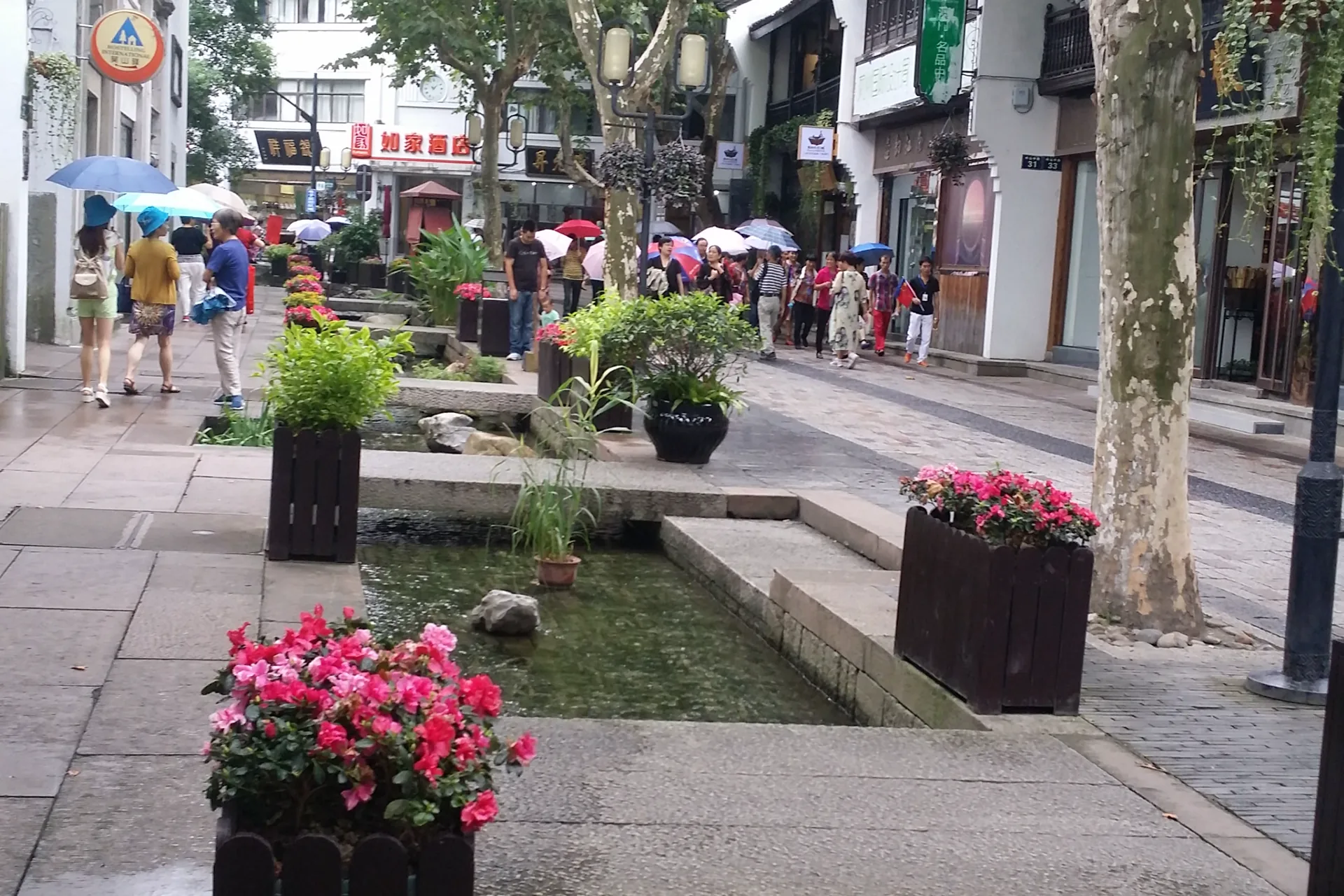 Historic storefronts and pedestrians along Hefang Street in Hangzhou