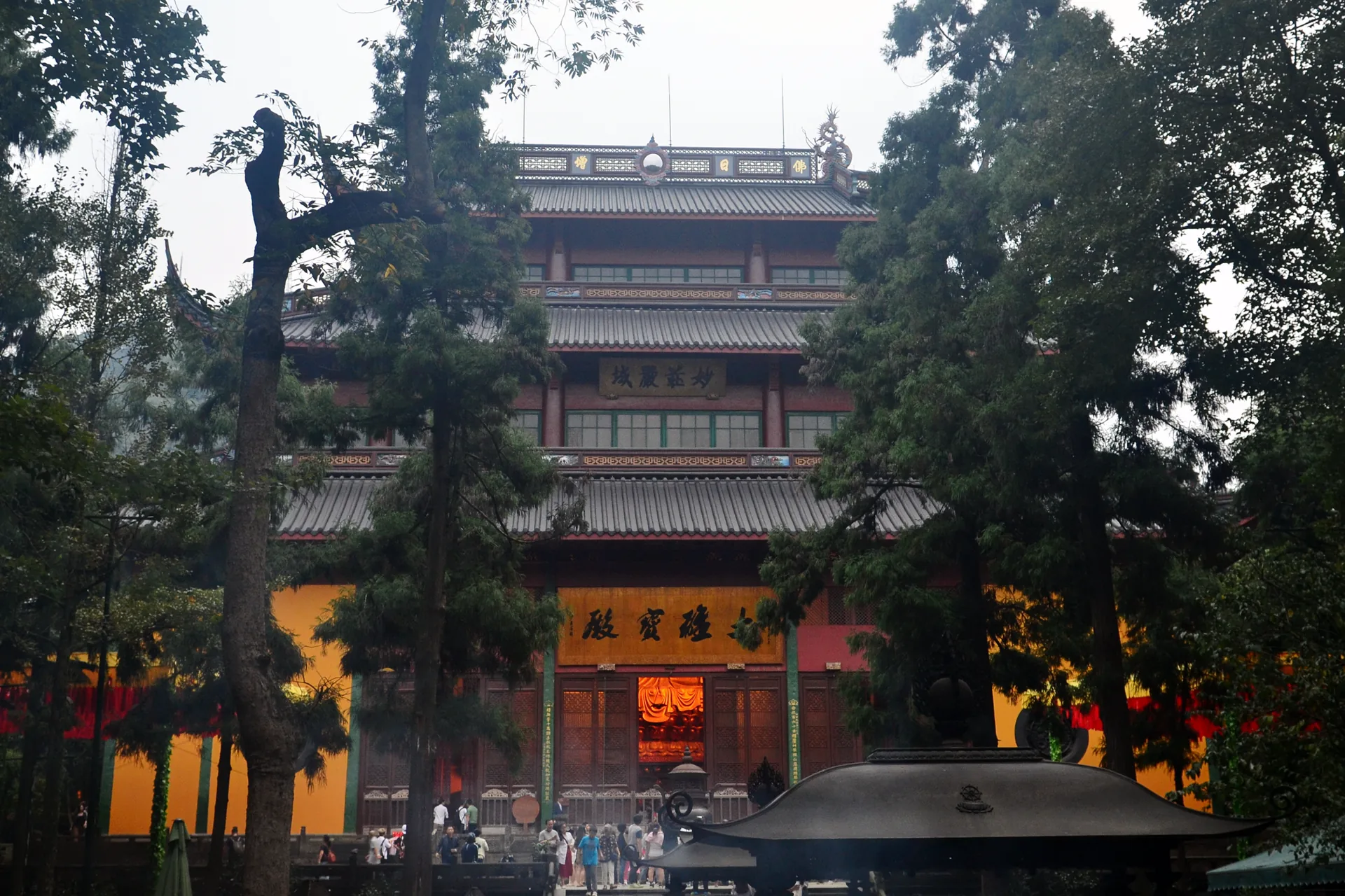 Lingyin Temple hall framed by mature trees in Hangzhou