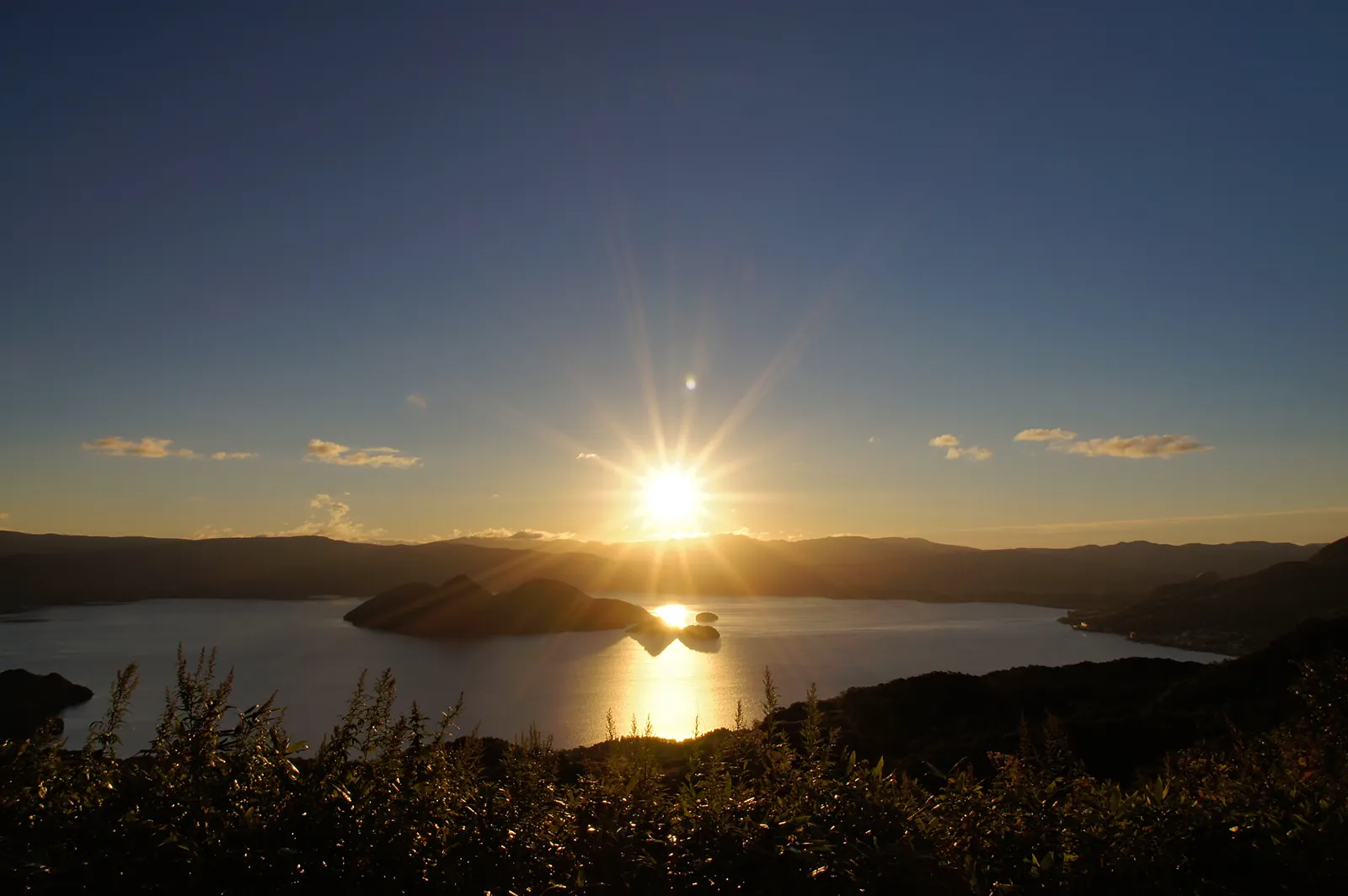 Lake Toya and its central islands under a blue sky
