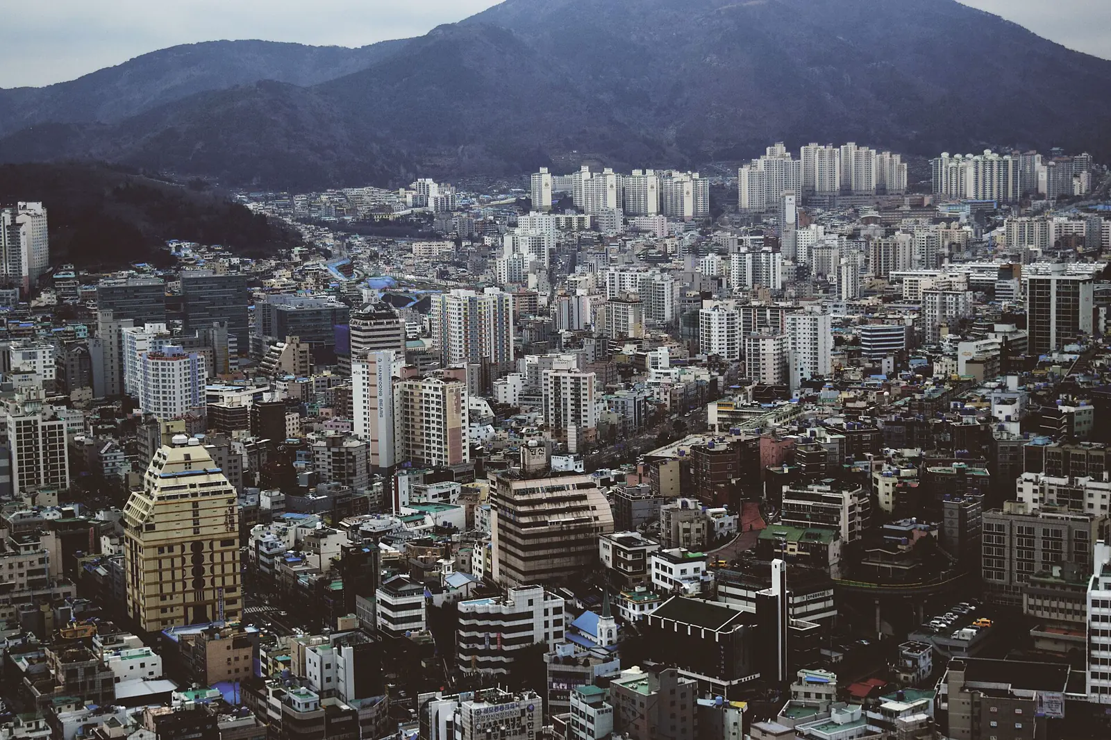 Busan neighborhoods rising between port towers and mountains