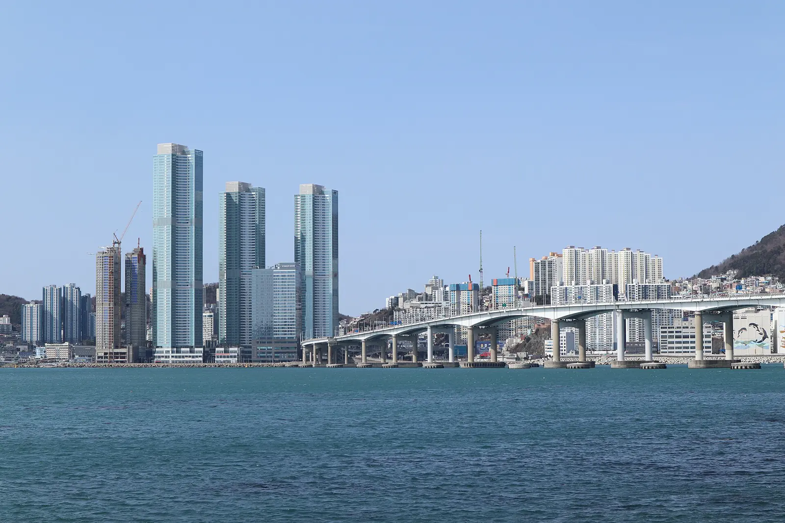 Songdo Beach, coastal towers and Namhang Bridge seen across the water
