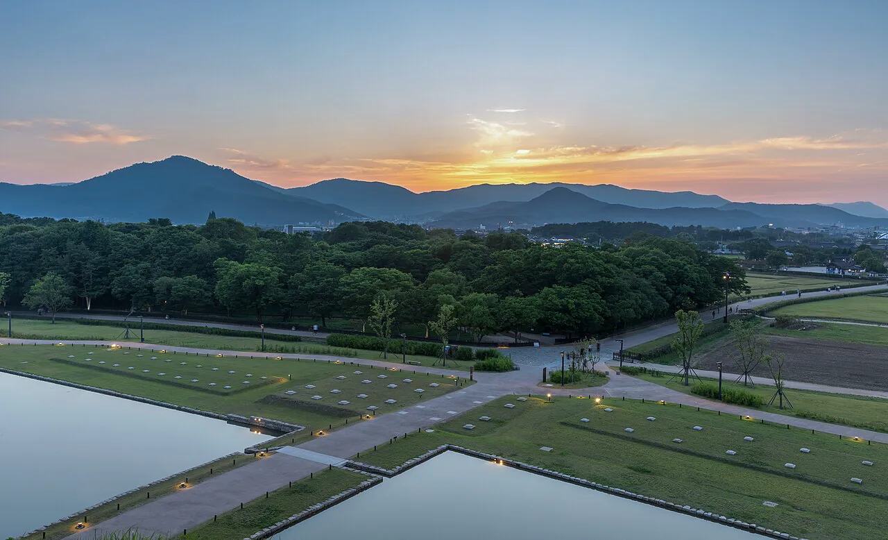 Gyeongju historic landscape and low mountains under a warm sunset