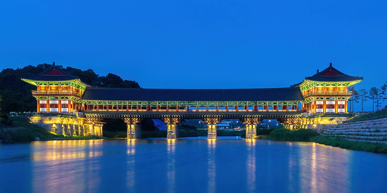 Woljeonggyo Bridge illuminated across the water at blue hour