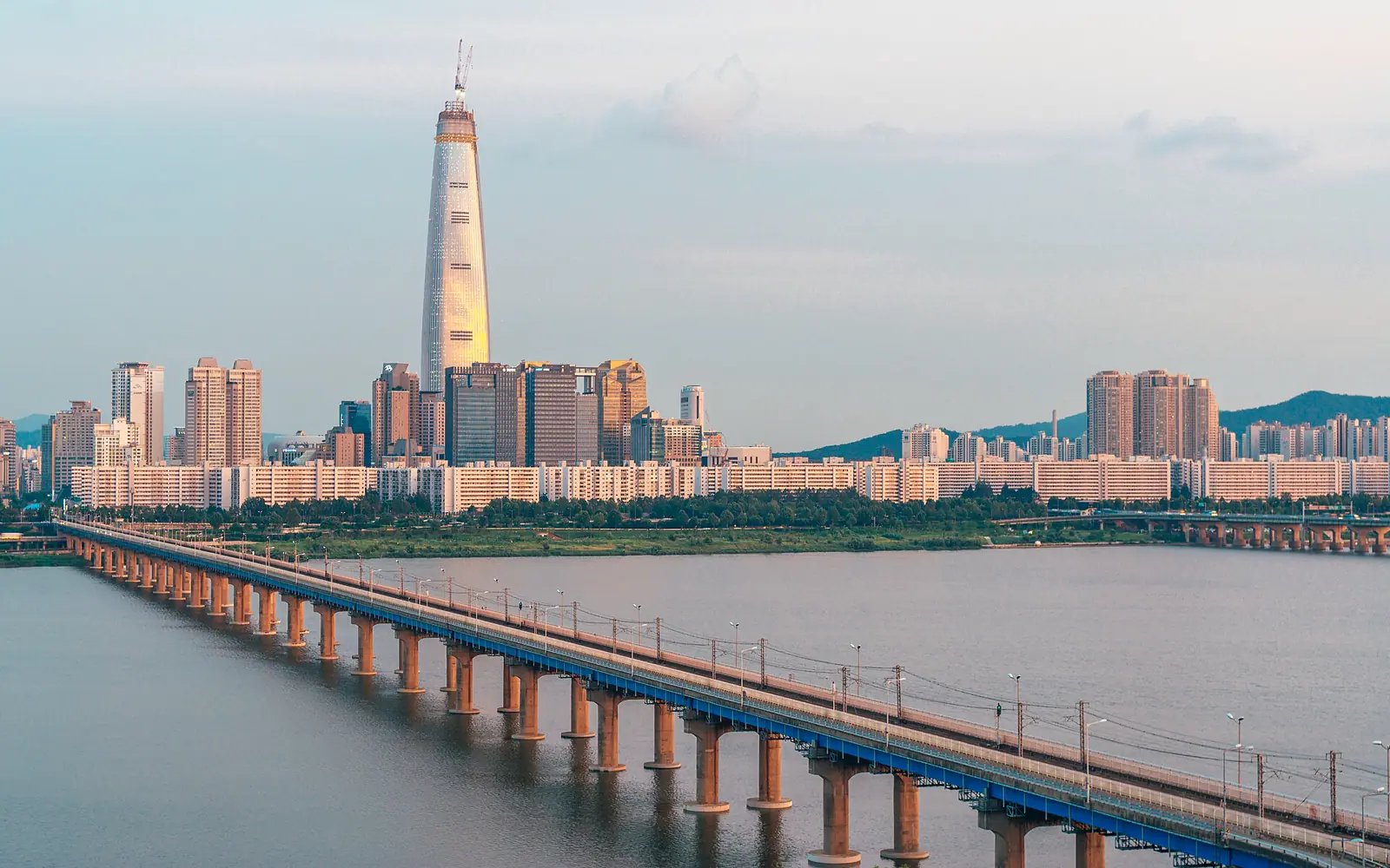 Lotte World Tower and Jamsil railway bridge at sunset