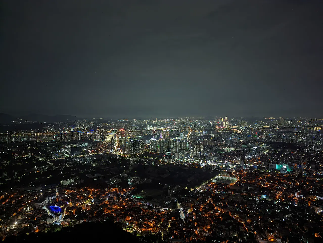 Seoul skyline glowing across the Han River at night