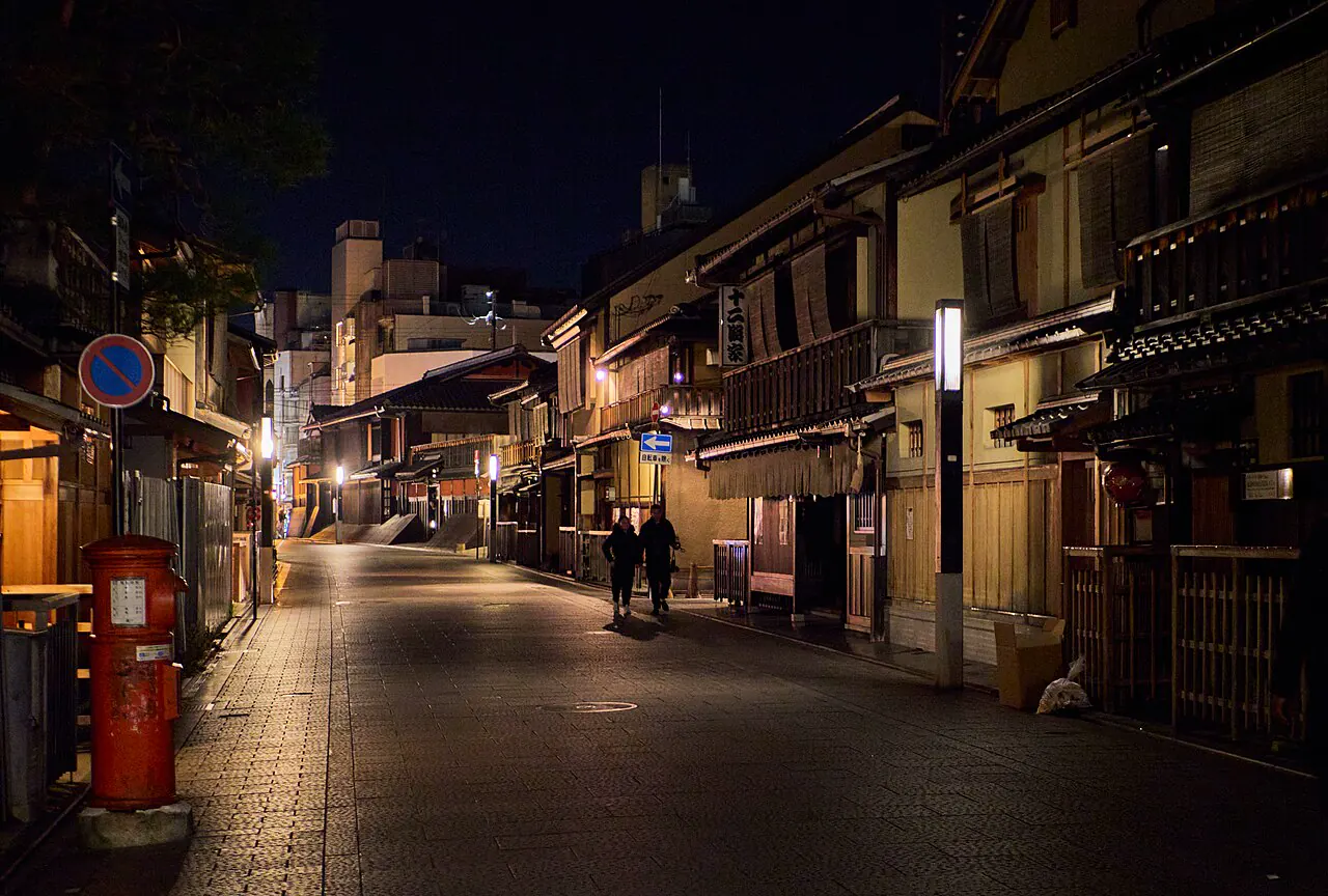 Traditional machiya facades along a quiet Gion street at night