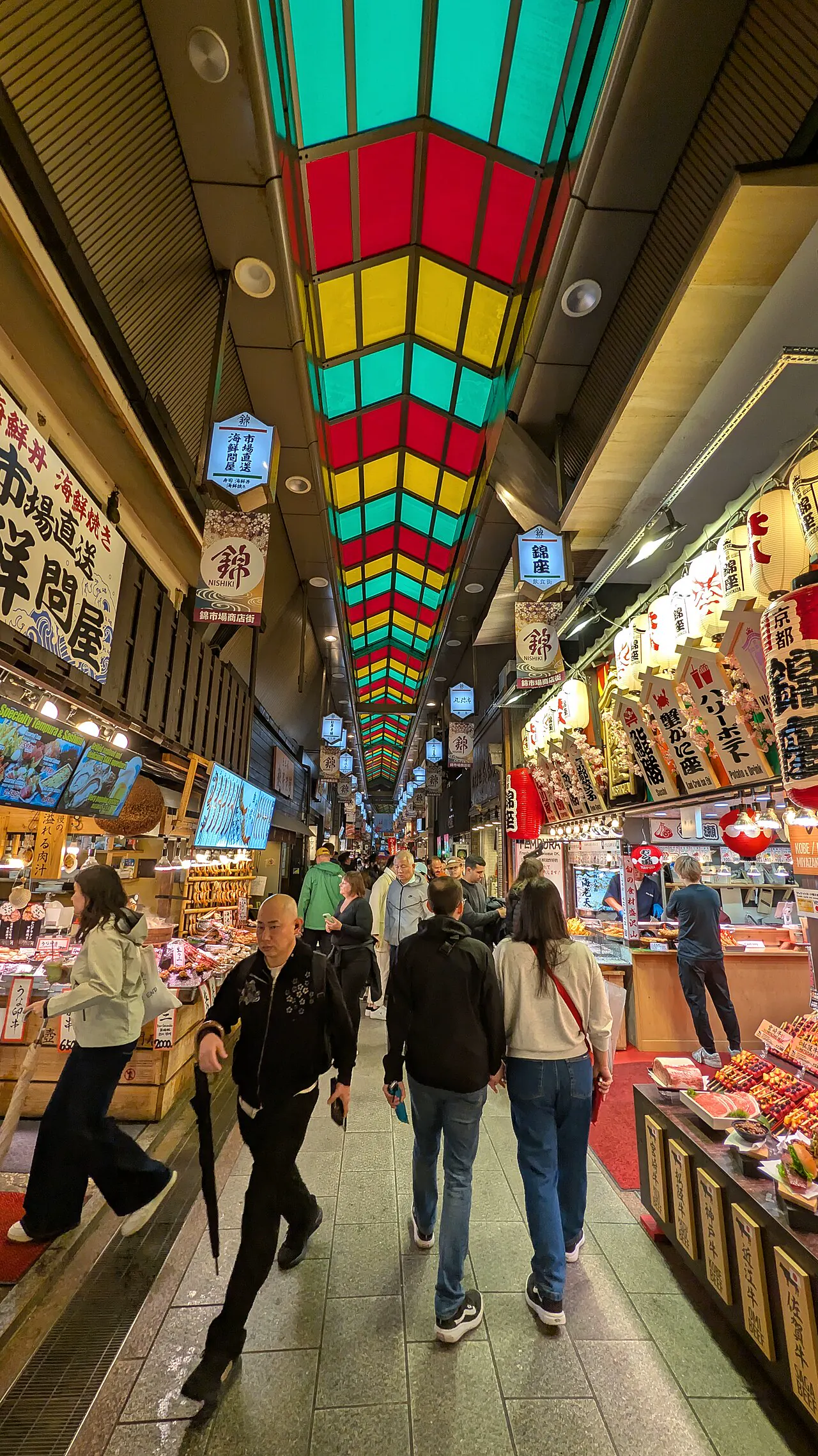 Colorful stalls beneath the stained-glass roof of Nishiki Market