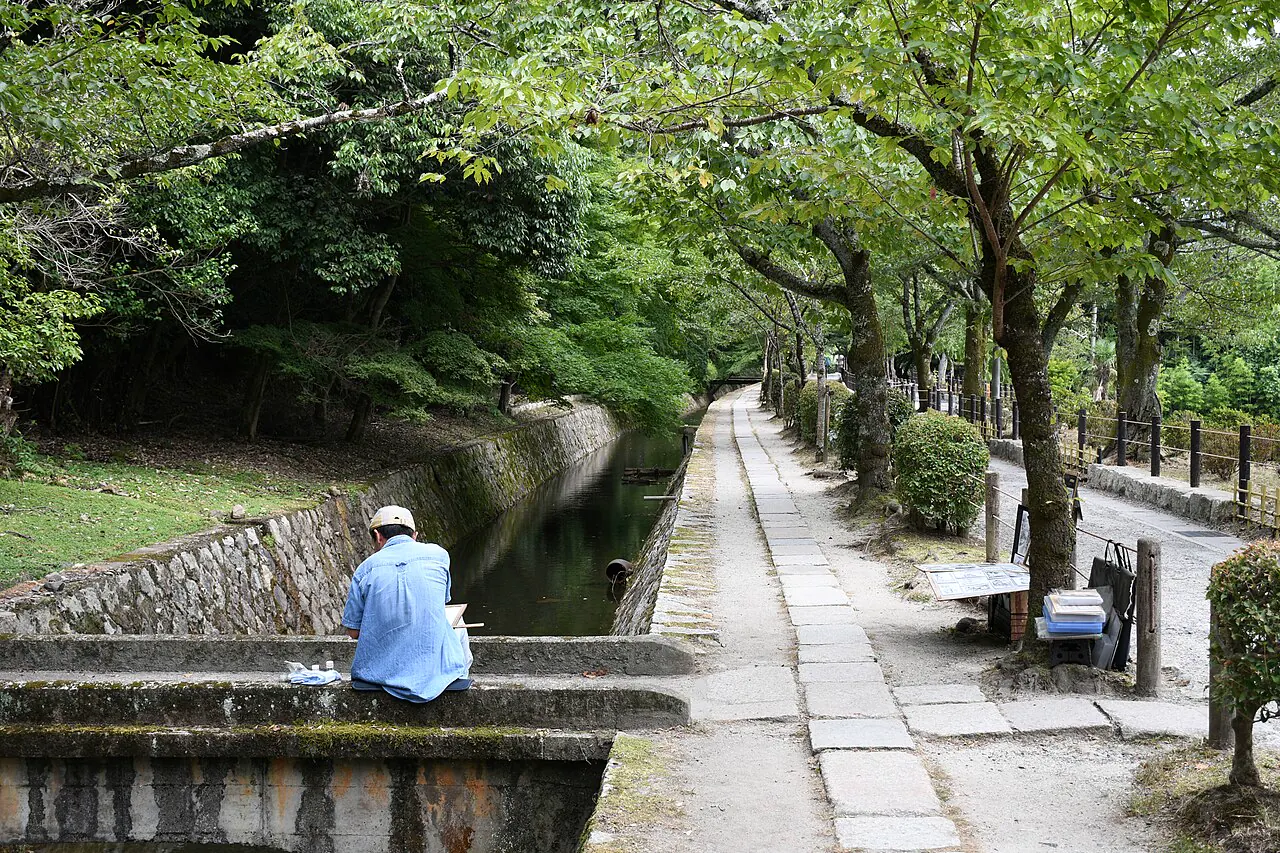 Green trees shading the canal beside Kyoto's Philosopher's Path