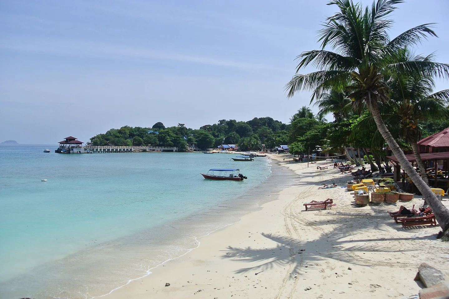 Boats resting in clear turquoise water at Coral Bay on Perhentian Kecil