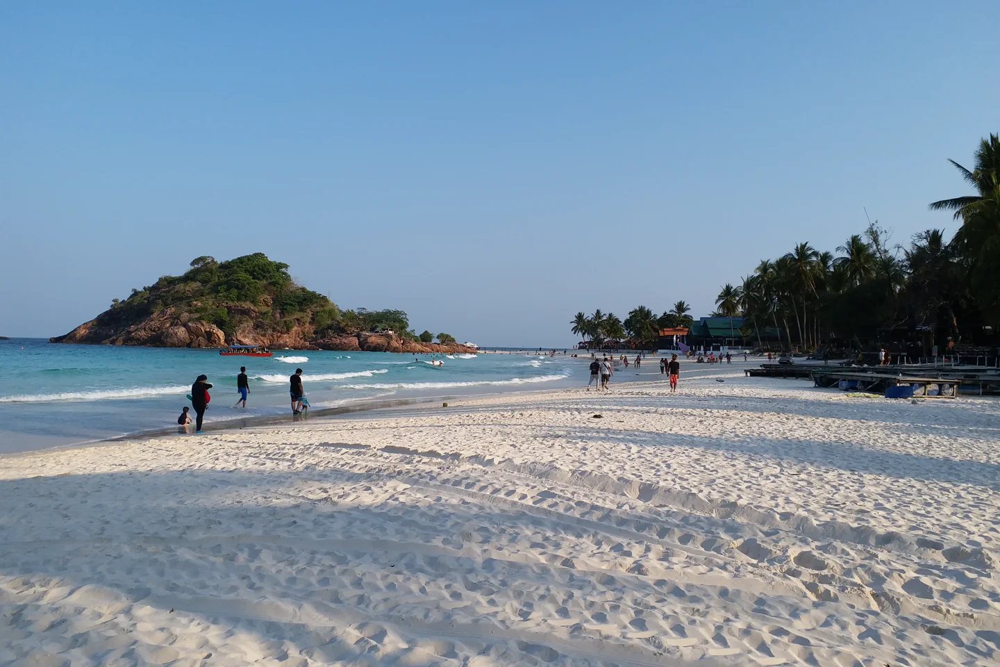 White sand, blue water and forested shore on Redang Island