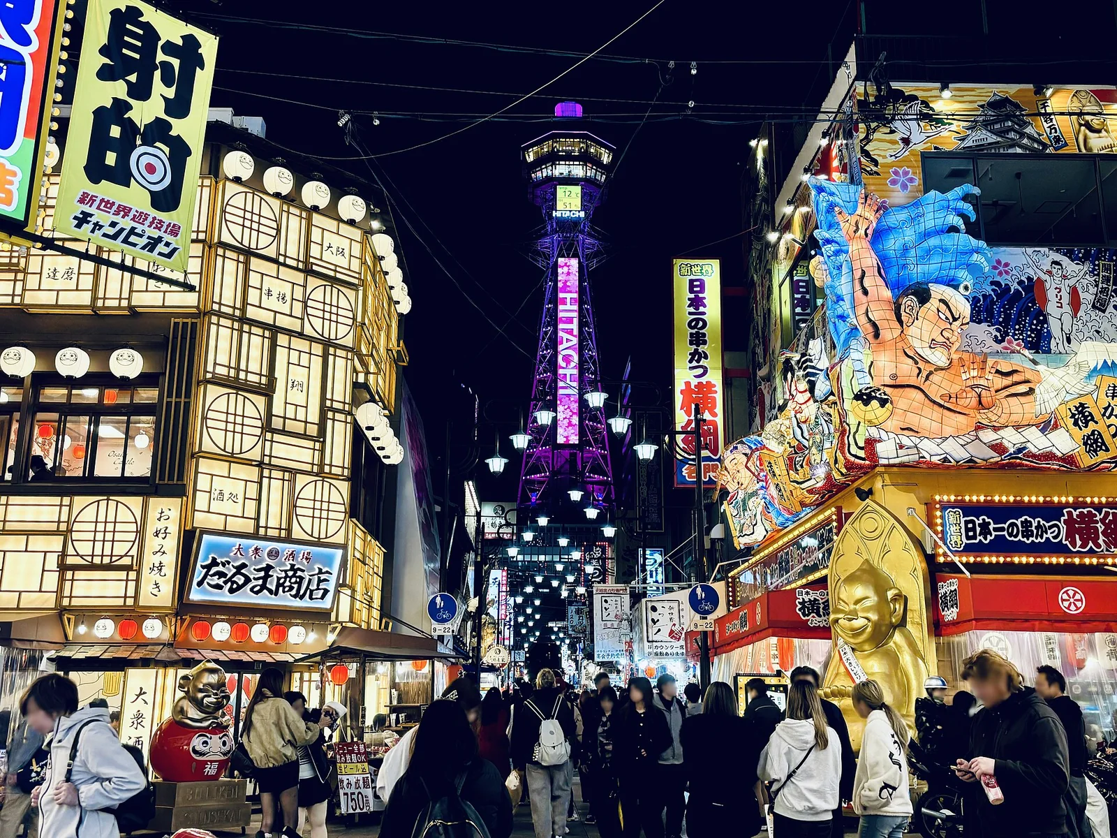 Colorful Shinsekai streets beneath Tsutenkaku Tower