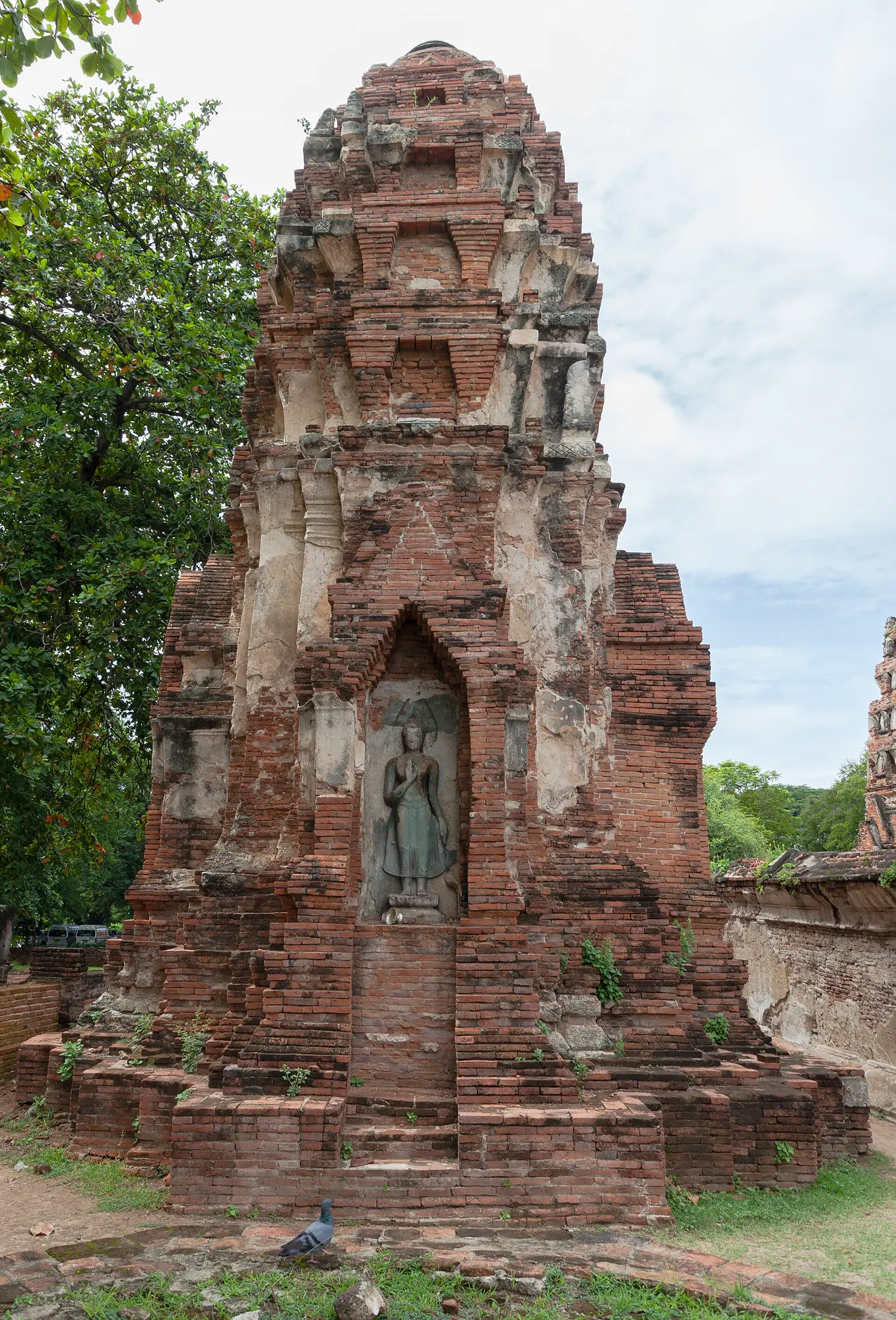 Brick prang and seated Buddha figure at Wat Mahathat in Ayutthaya