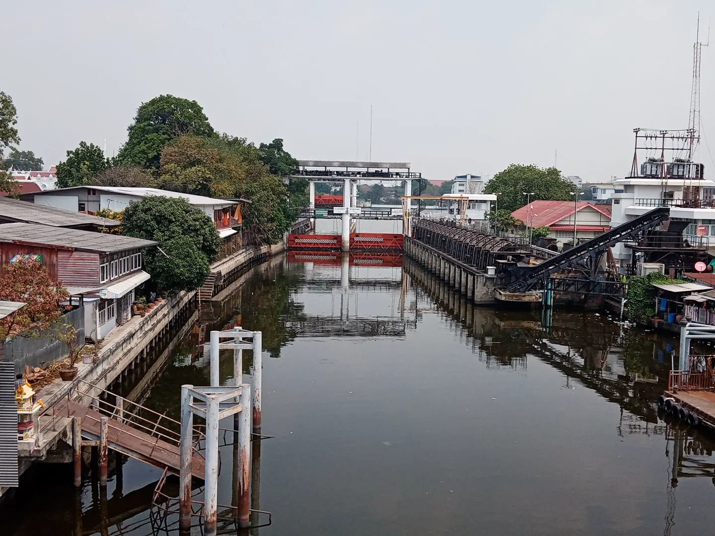 Waterfront buildings and a canal gate on Khlong Bangkok Yai