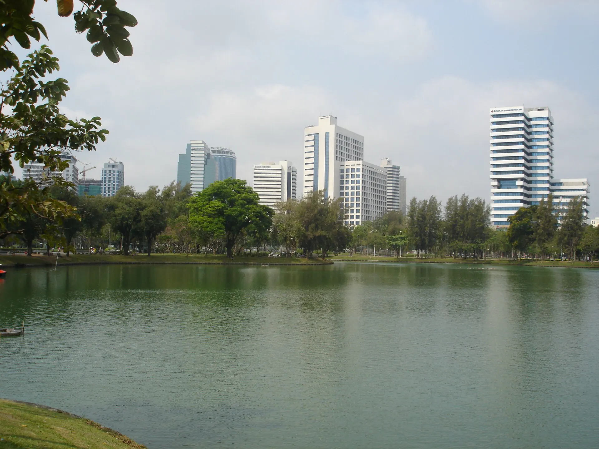 Lumphini Park lake with central Bangkok buildings beyond