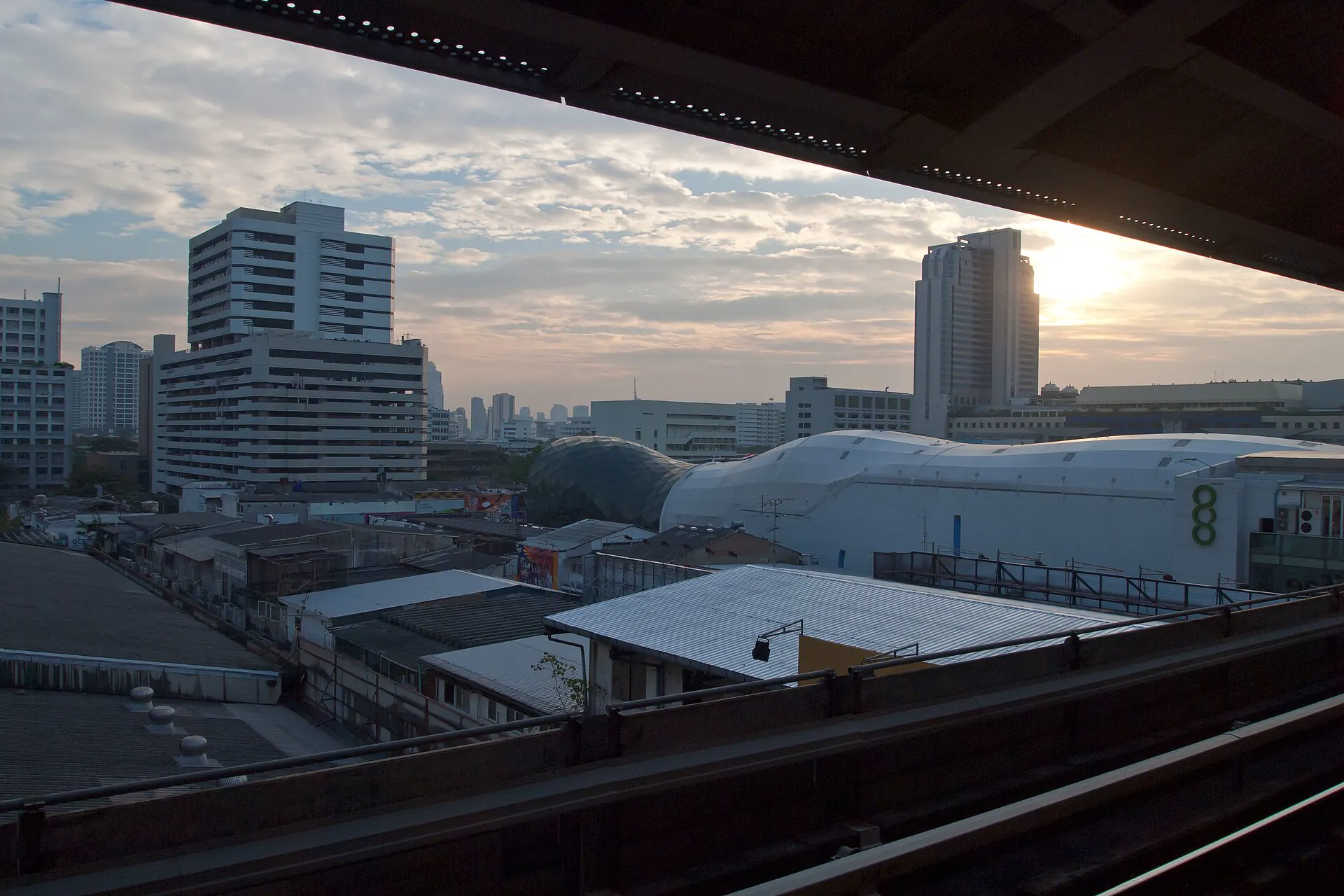 Central Bangkok skyline at sunset framed by Siam BTS structure