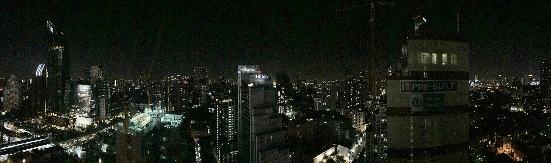 Wide nighttime panorama of towers along Sukhumvit