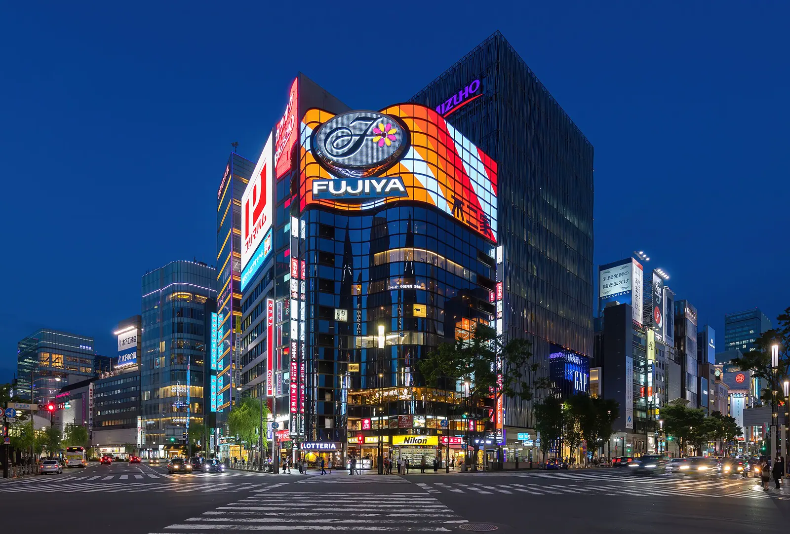 Illuminated Fujiya corner building in Ginza at blue hour