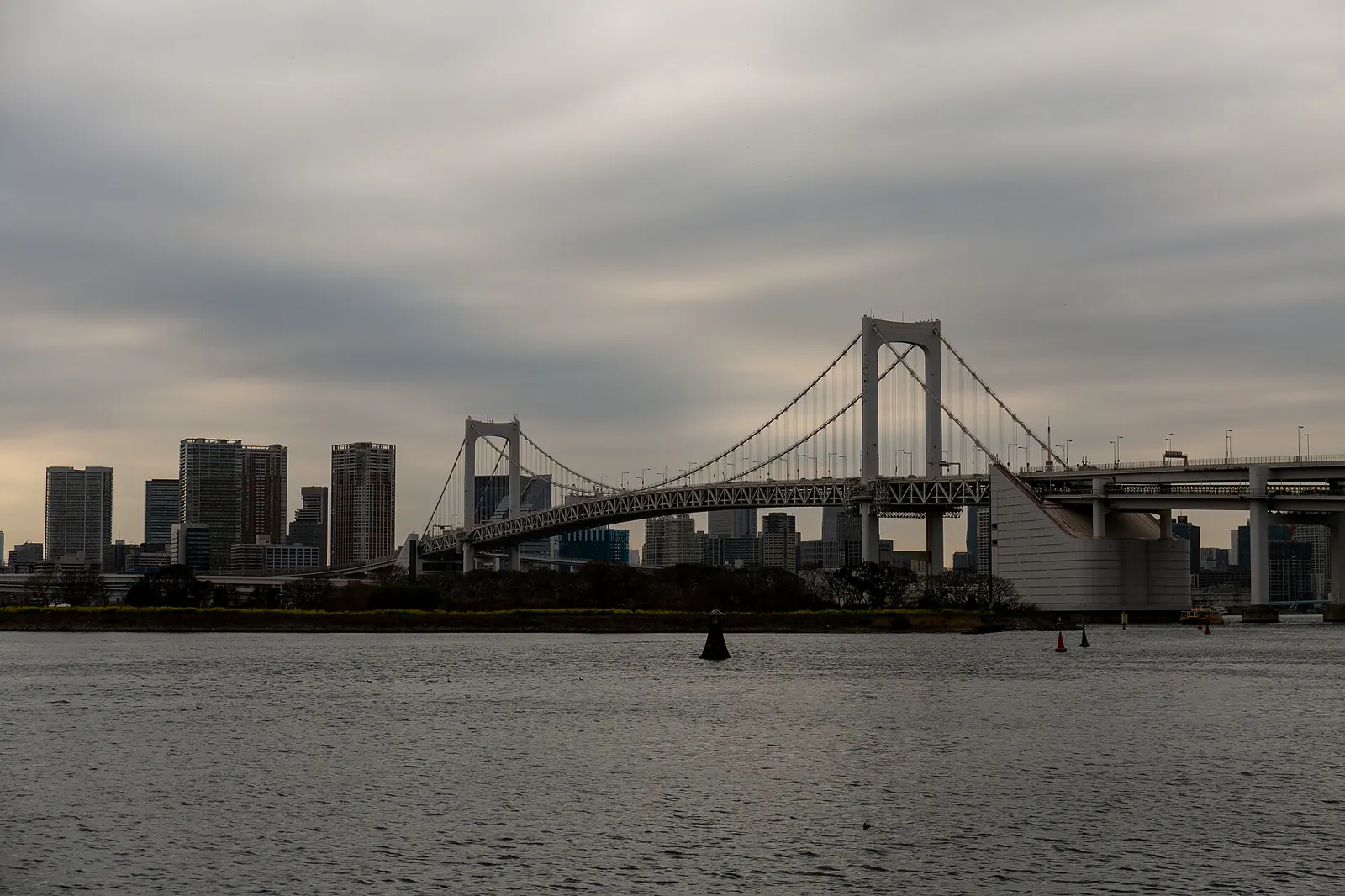 Rainbow Bridge and Tokyo skyline viewed across Odaiba waterfront