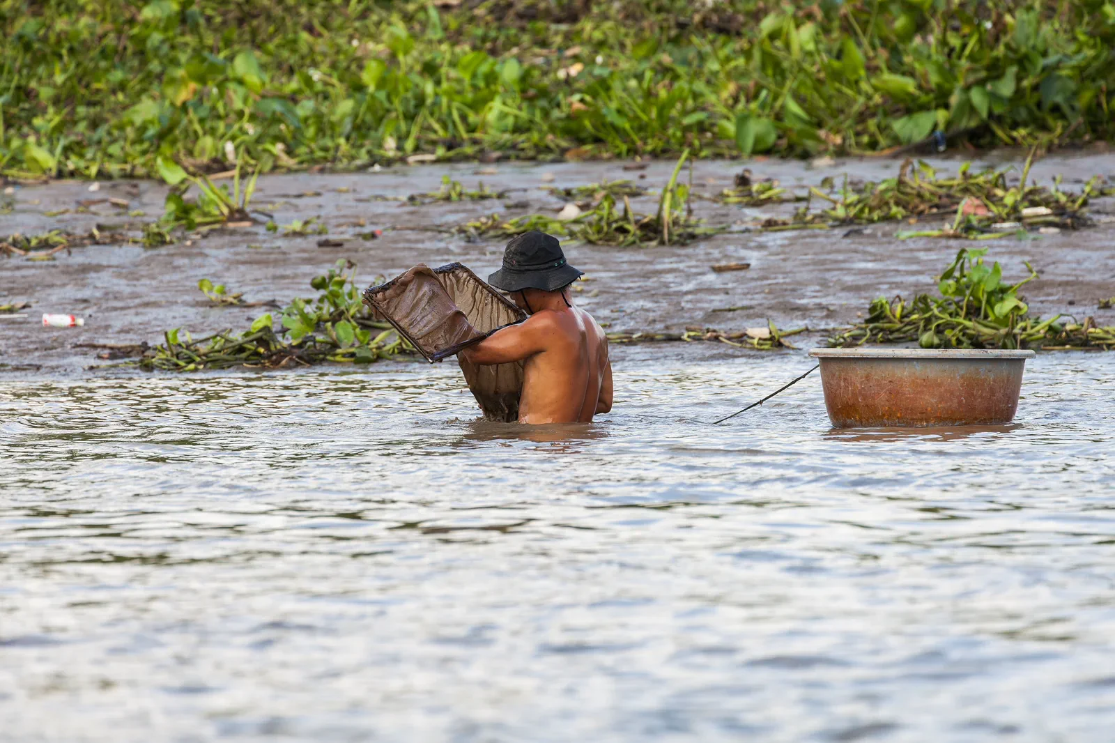 Fishermen working on the Saigon River beside Ho Chi Minh City